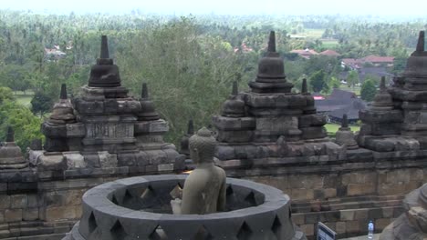 Buddha-inside-a-stupa-at-Borobudur-Temple,-UNESCO-World-Heritage-Site,-Central-Java,-Indonesia,-Buddhist-Temple