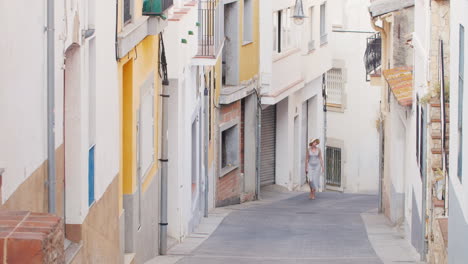 woman tourist is vverhpo narrow street in the old quarter of the old city lloret de mar spain touris