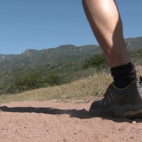 Low-angle-of-man-trail-running-on-the-Ventura-River-Preserve-in-Ojai-California