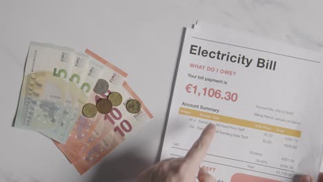 hand counting currency in euros to pay for european electricity energy bill