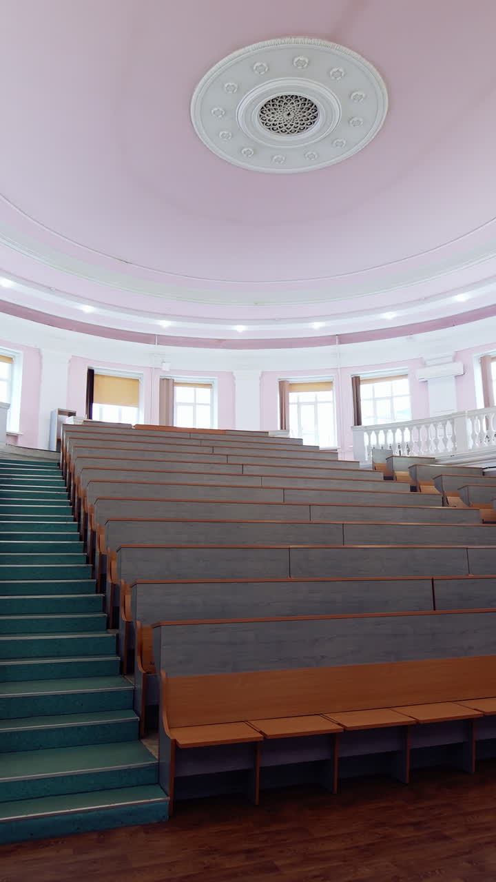 Modern auditorium for lectures. Empty conference hall at the university. Meeting room for educational purpose. Motion camera back to the door. Vertical video