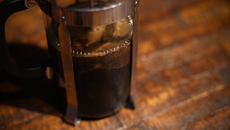 coffee being filtered from the grounds in a french press