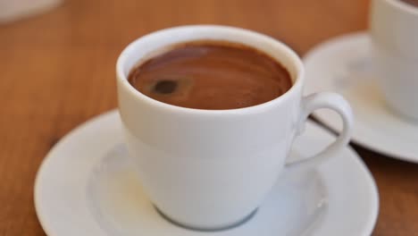 dos tazas de café turco en una mesa de madera