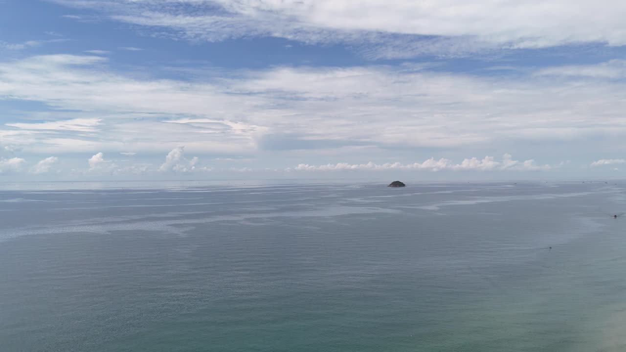 Aerial View Dolly of the Sea and a Small Island at Sea in La Gi