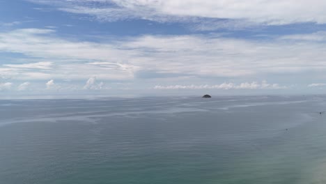 aerial view dolly of the sea and a small island at sea in la gi