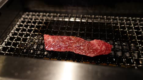 steak being seasoned, cooked, and flipped on grill