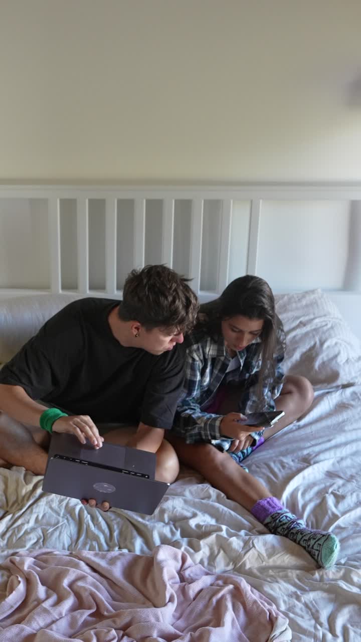 Young Couple Working or Studying in Bed