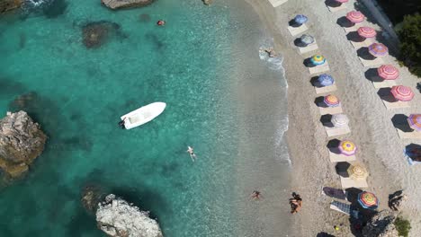 Swimmers-enjoy-beautiful-day-at-tropical-sandy-beach-in-protected-cove-or-bay