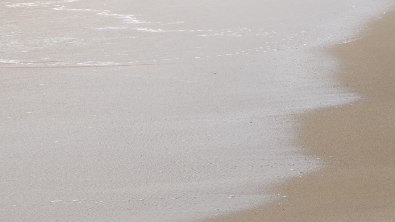 la suave ola golpea la playa.