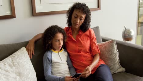 Front-view-of-African-american-mother-talking-with-her-son-in-the-lobby-at-hospital-4k