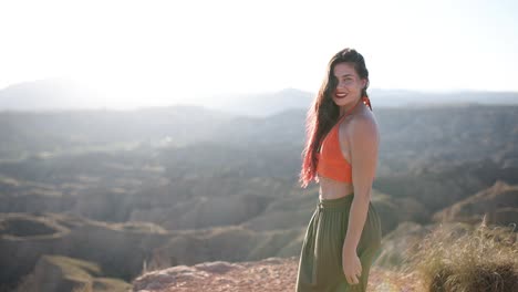 joyful young woman enjoying the sunny desert landscape