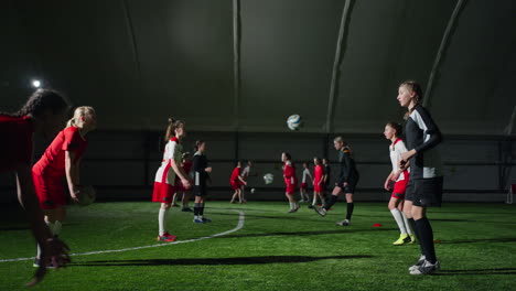 young girls soccer players practice indoors