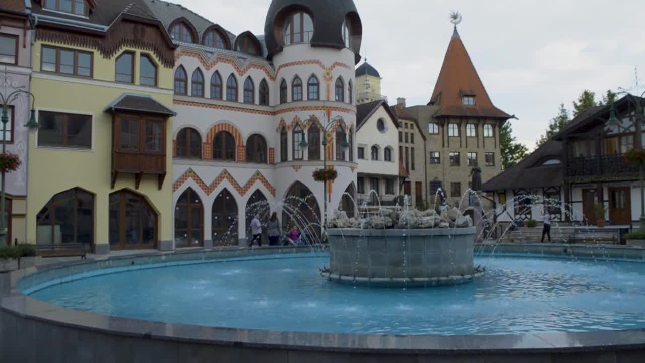 Panning view of  town square with a huge stone fountain