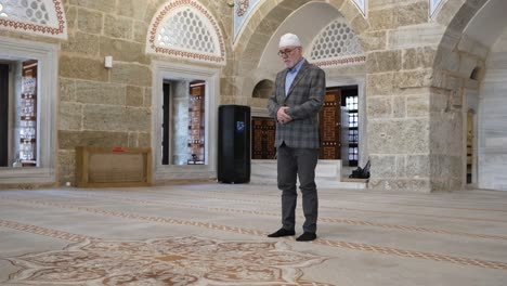 man praying in mosque