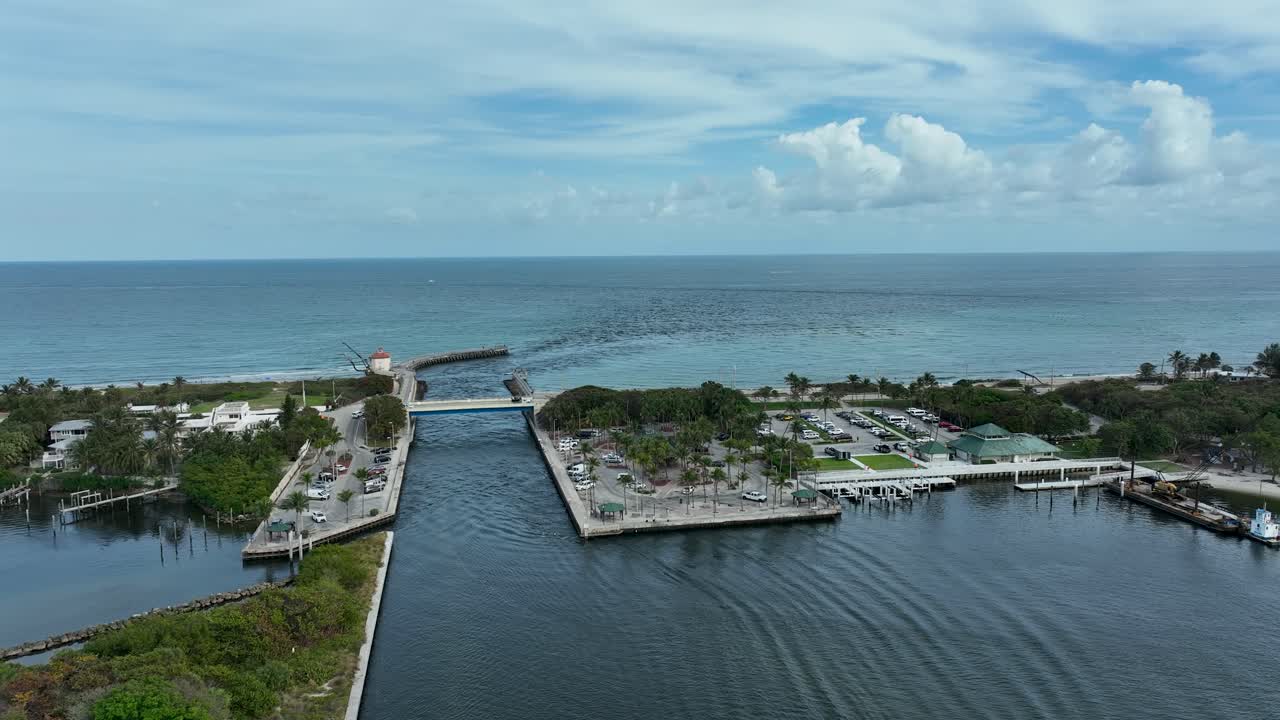 Drone flying slowly from Intracoastal Park over the Intracoastal Waterway toward Ocean Inlet Park in Boynton Beach Florida
