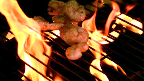 prawns being cooked on flaming barbecue