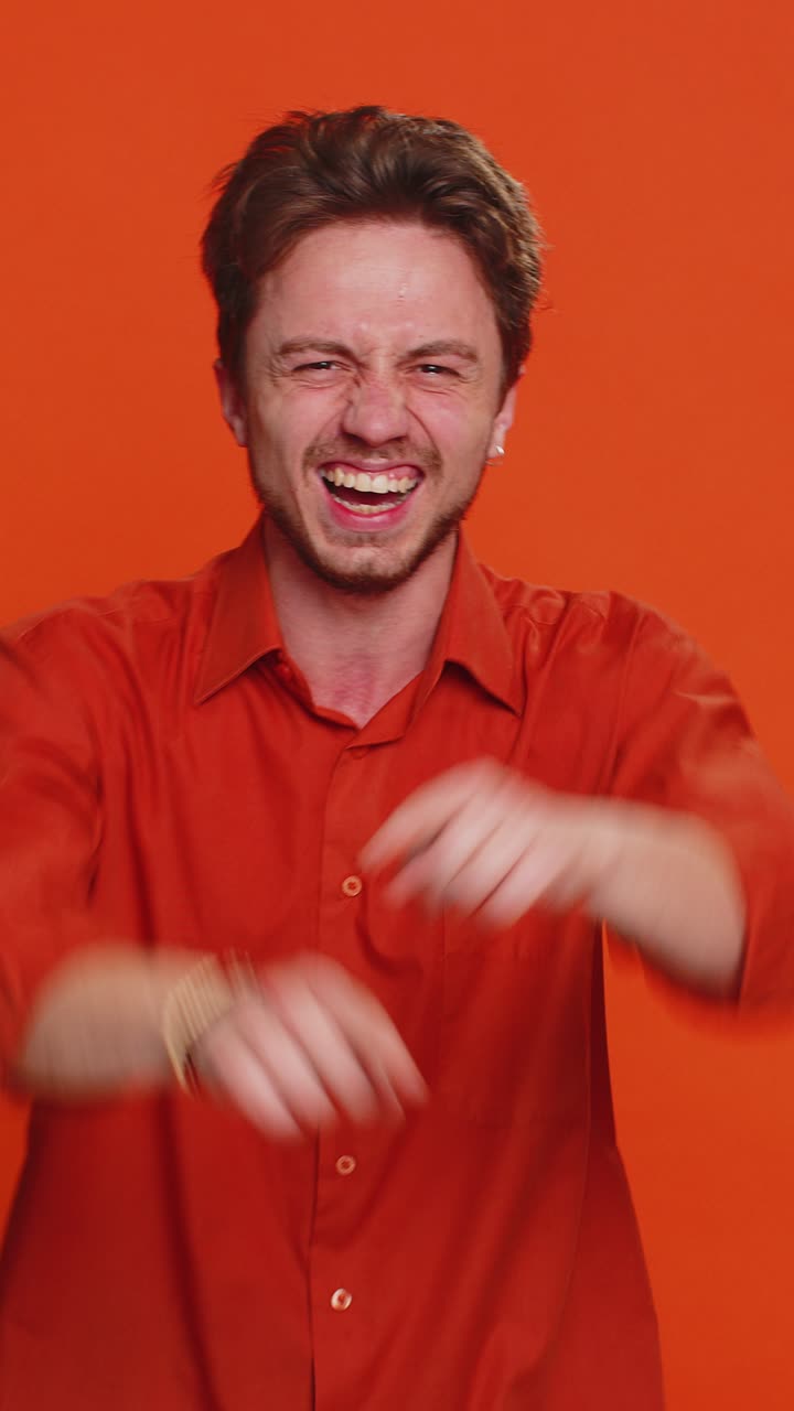Happy excited young man laughing out loud after hearing ridiculous anecdote reaction on funny joke