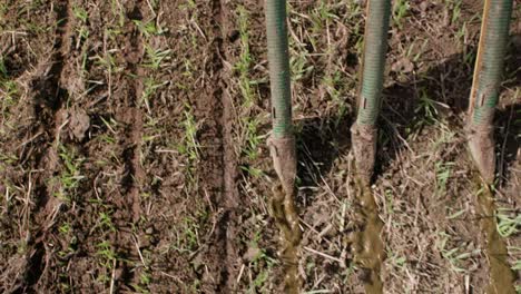 liquid manure spreader releasing slurry on field close up slow motion