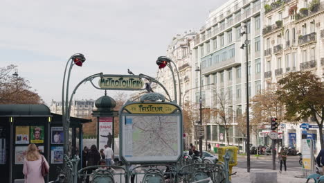 street view of people walking by pasteur metro station in paris, france