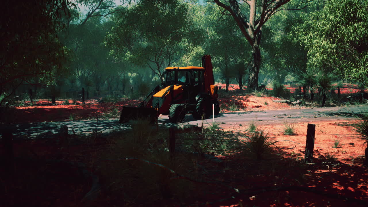 덤불 숲 에 있는 발굴기 트랙터