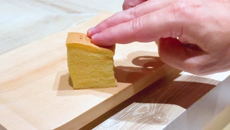 hand interacting with a japanese dessert piece