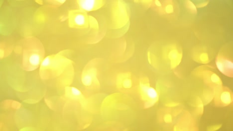 fondo parpadeante. textura borrosa de resplandor dorado. textura sin costuras con pañuelos de oro amarillo