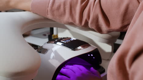 Woman getting her nails done at a nail salon