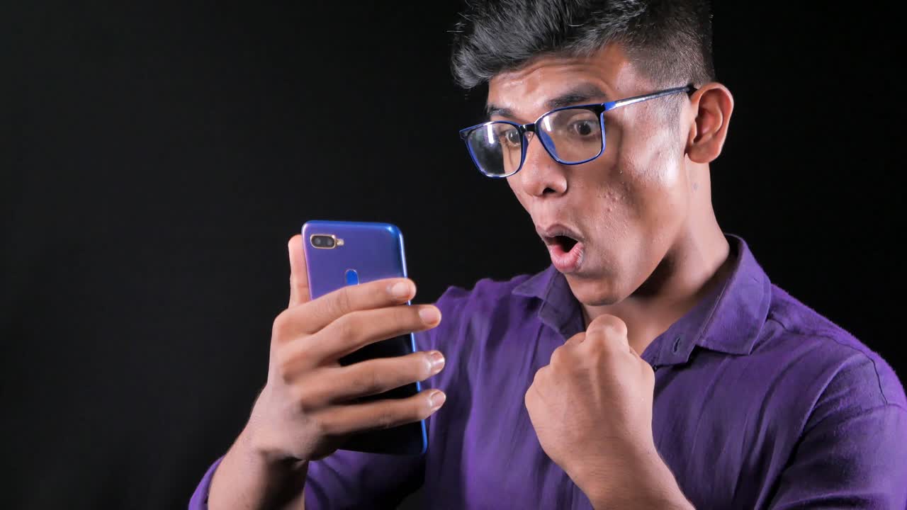 Young Man Reacting to His Smartphone