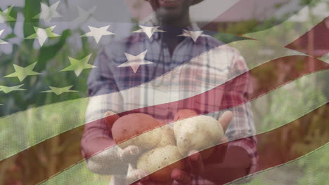 animation of flag of united states of america over african american farmer keeping potatos