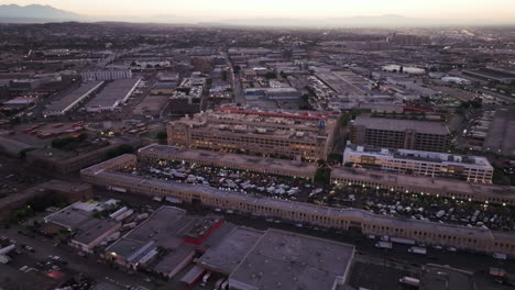 aerial view of a bustling city market and industrial area at dusk