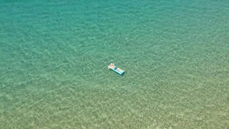 drone shot of a person on a inflatable mattress