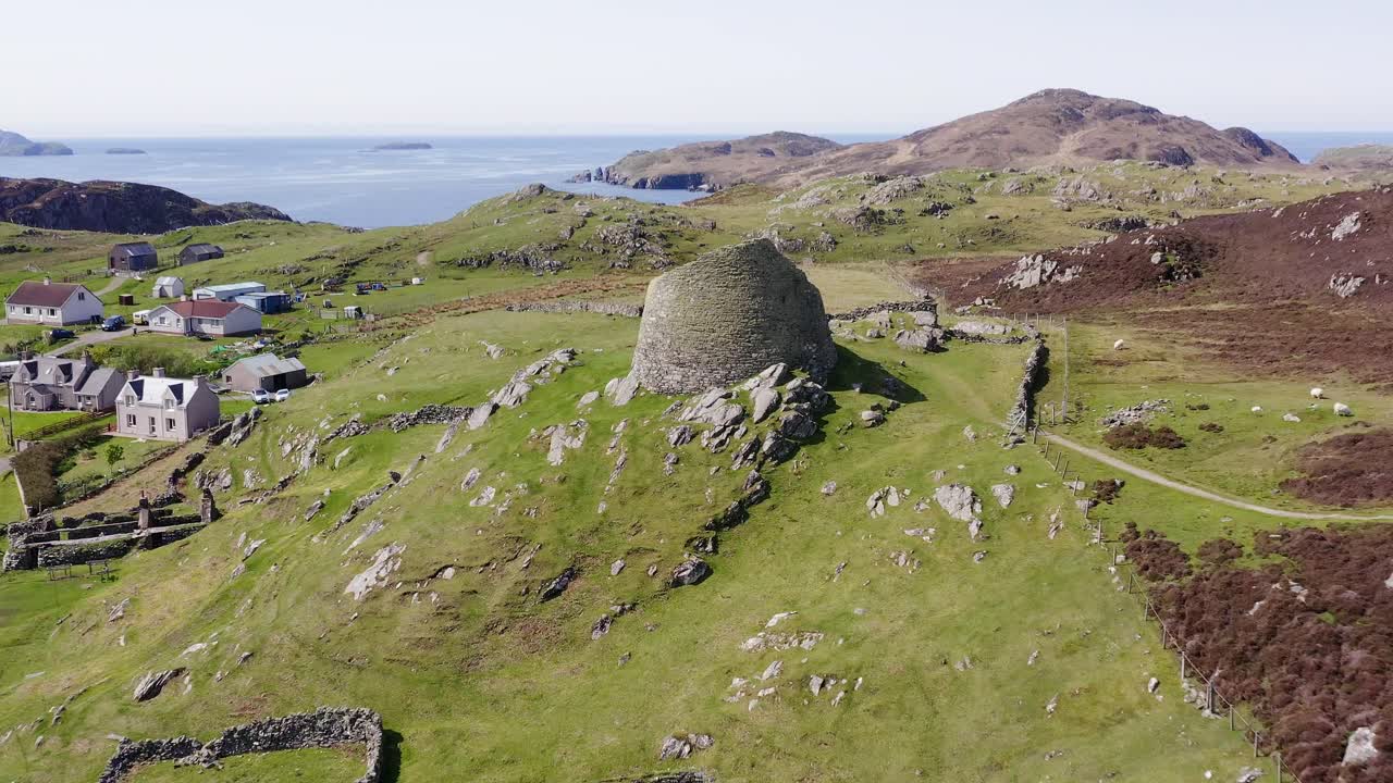 Tilting drone shot of the 'Dun Carloway Broch' on the west coast of the Isle of Lewis, part of the Outer Hebrides of Scotland