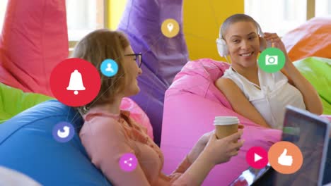 social media icons moving against two woman friends laughing