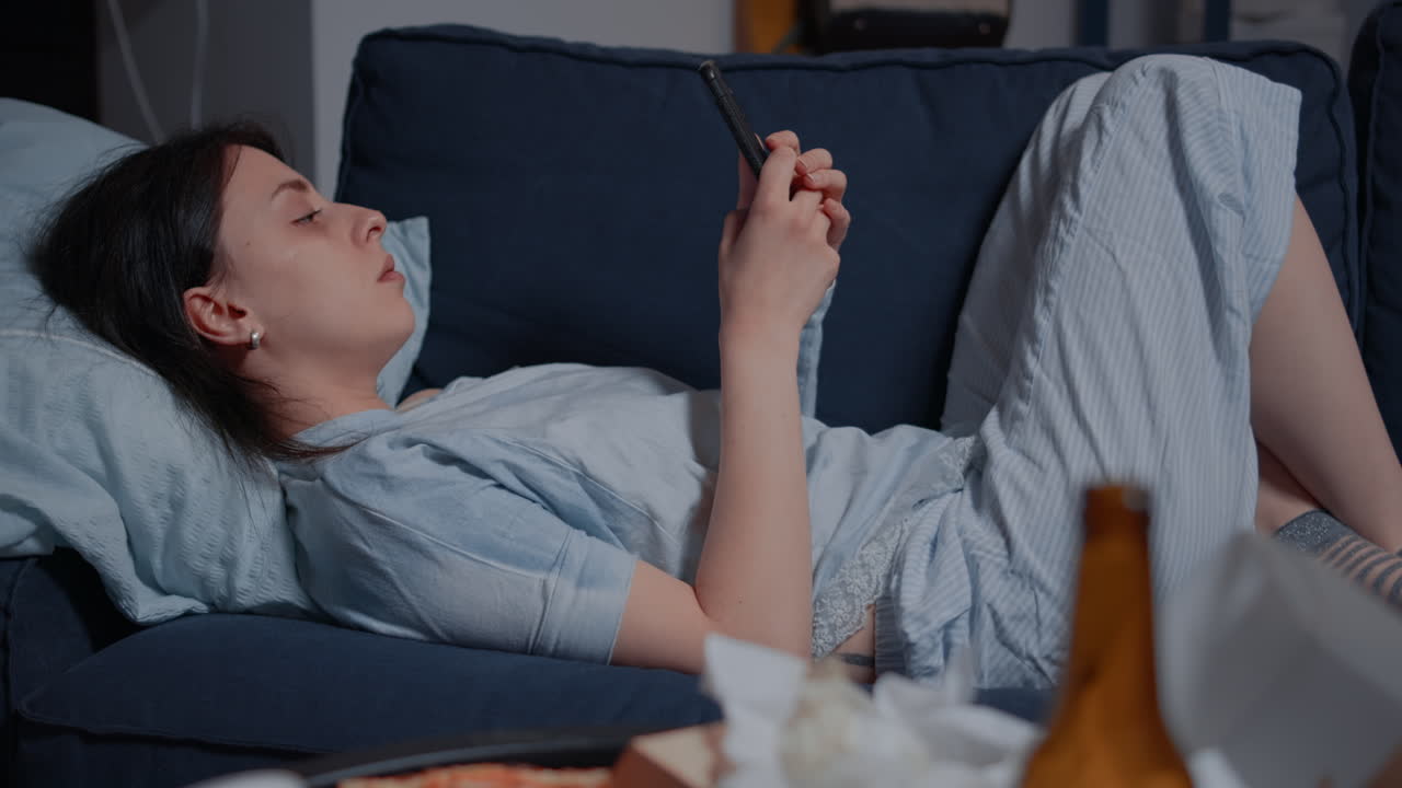 Unhappy, depressed alone woman by warning notification for unpaid bank bills