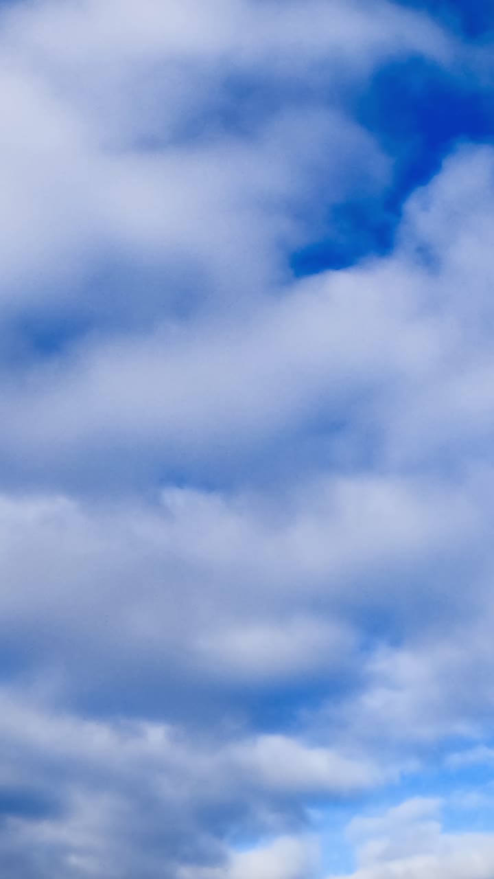 Clouds accumulating in the atmosphere. Low angle view on the rain cloudscape formation. Vertical video