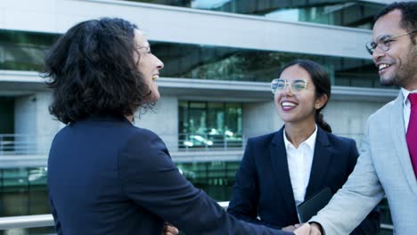 cheerful business people greeting each other