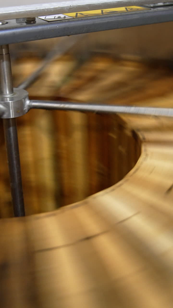Honey frames are rotated in the centrifuge. Close up. Removal of fresh harvest of honey in the extractor machine. Vertical video