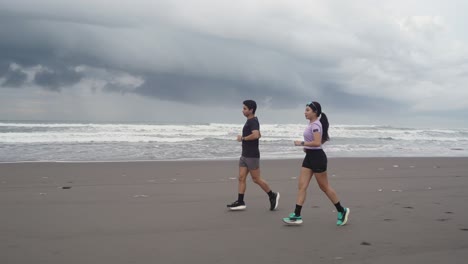 couple running on a stormy beach