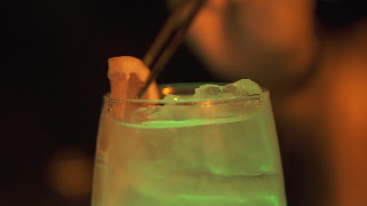 Refreshing summer cocktail glowing at night, tropical luxury drink concept