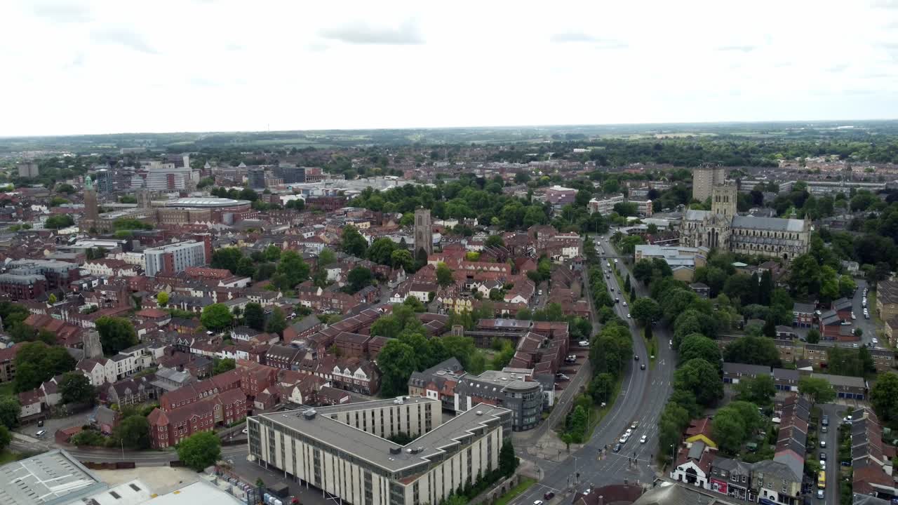 Rotating around Norwich City wide aerial footage highlights the city's architecture including cathedral, mall and center homes including blocks of flats.