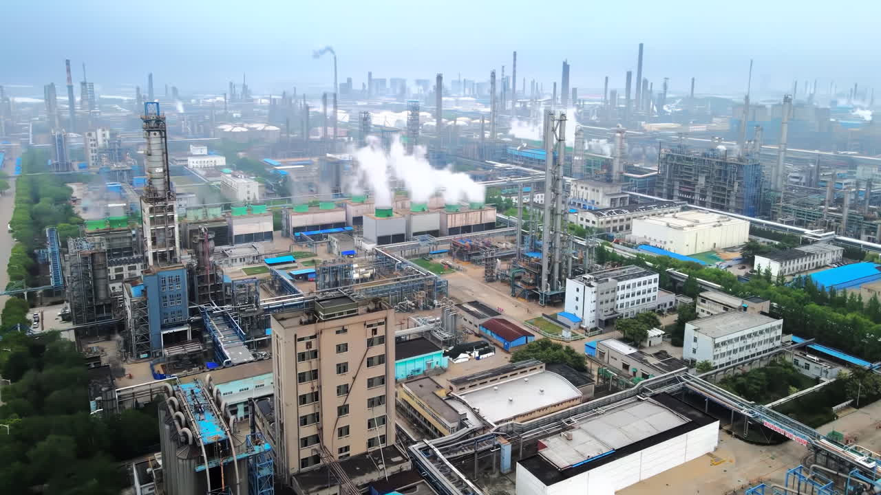 Factory tall chimney releasing thick plumes of smoke into the air, depict industrial area refinery chemical plant pollution and environmental concerns.