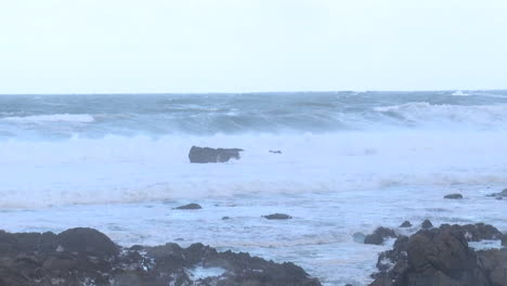 stormy ocean waves crashing on rocks