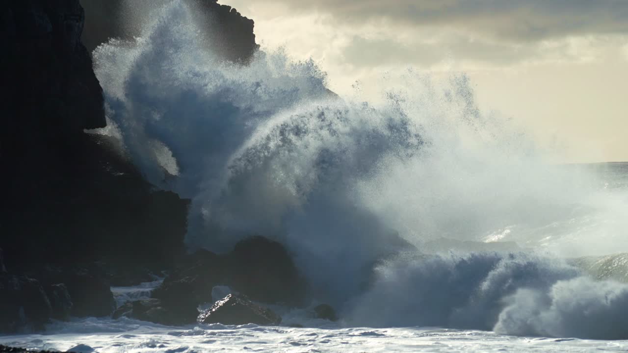 Extreme slow motion of beautiful ocean waves crashing into Kaiaka Rock Molokai Hawaii 8