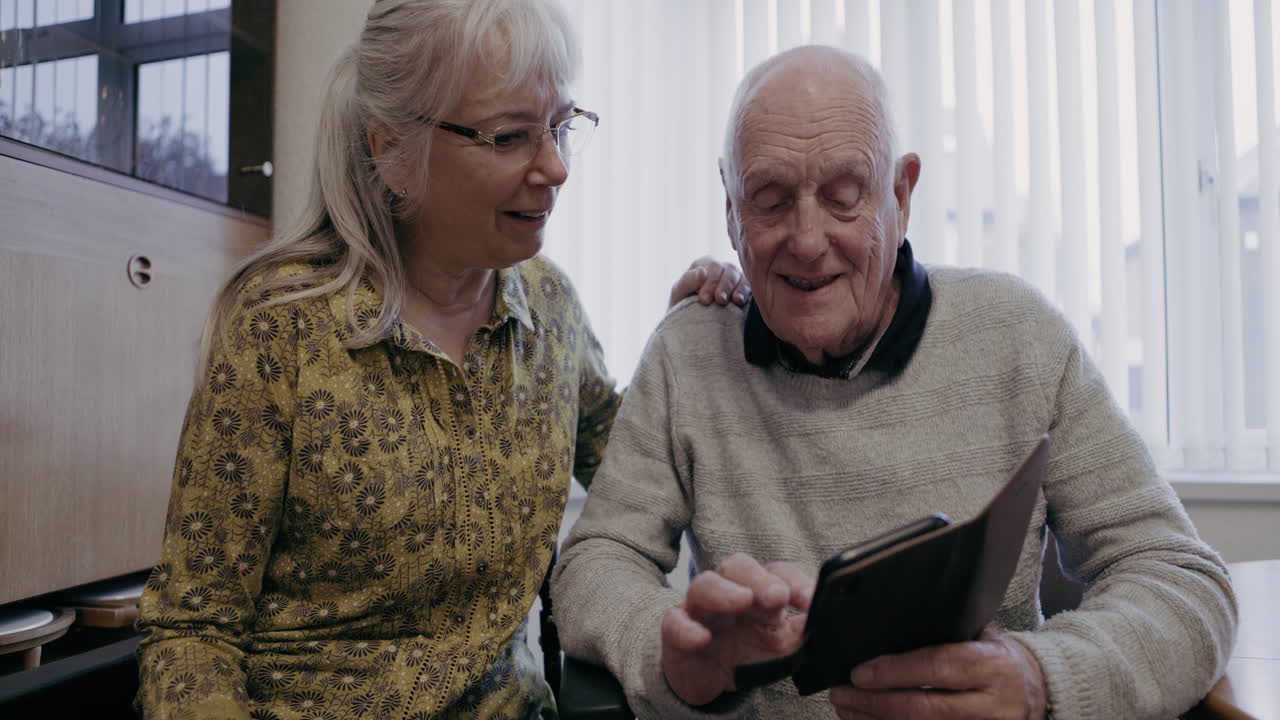 A heartwarming moment between an elderly couple sharing memories