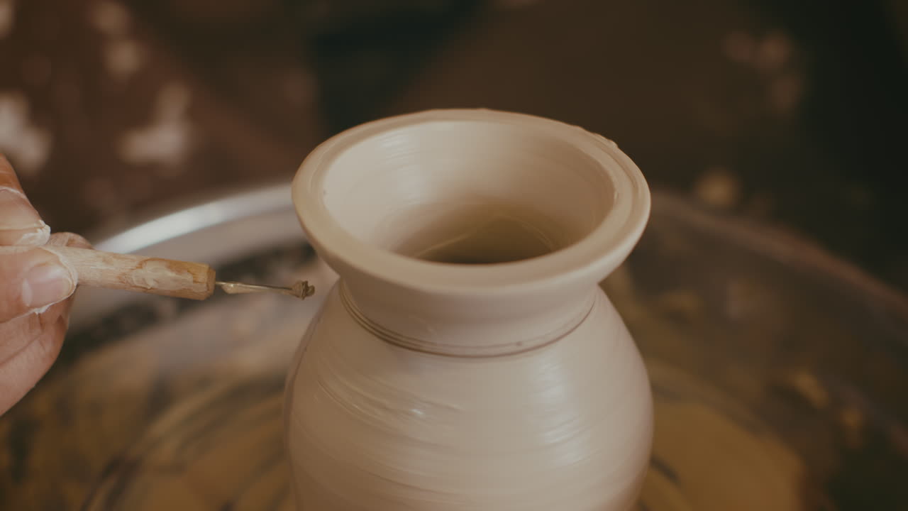 Pottery Artist Shaping a Vase on a Wheel