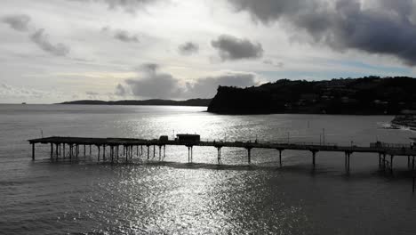 silhouette of teignmouth's grand pier reaching out in the english channel