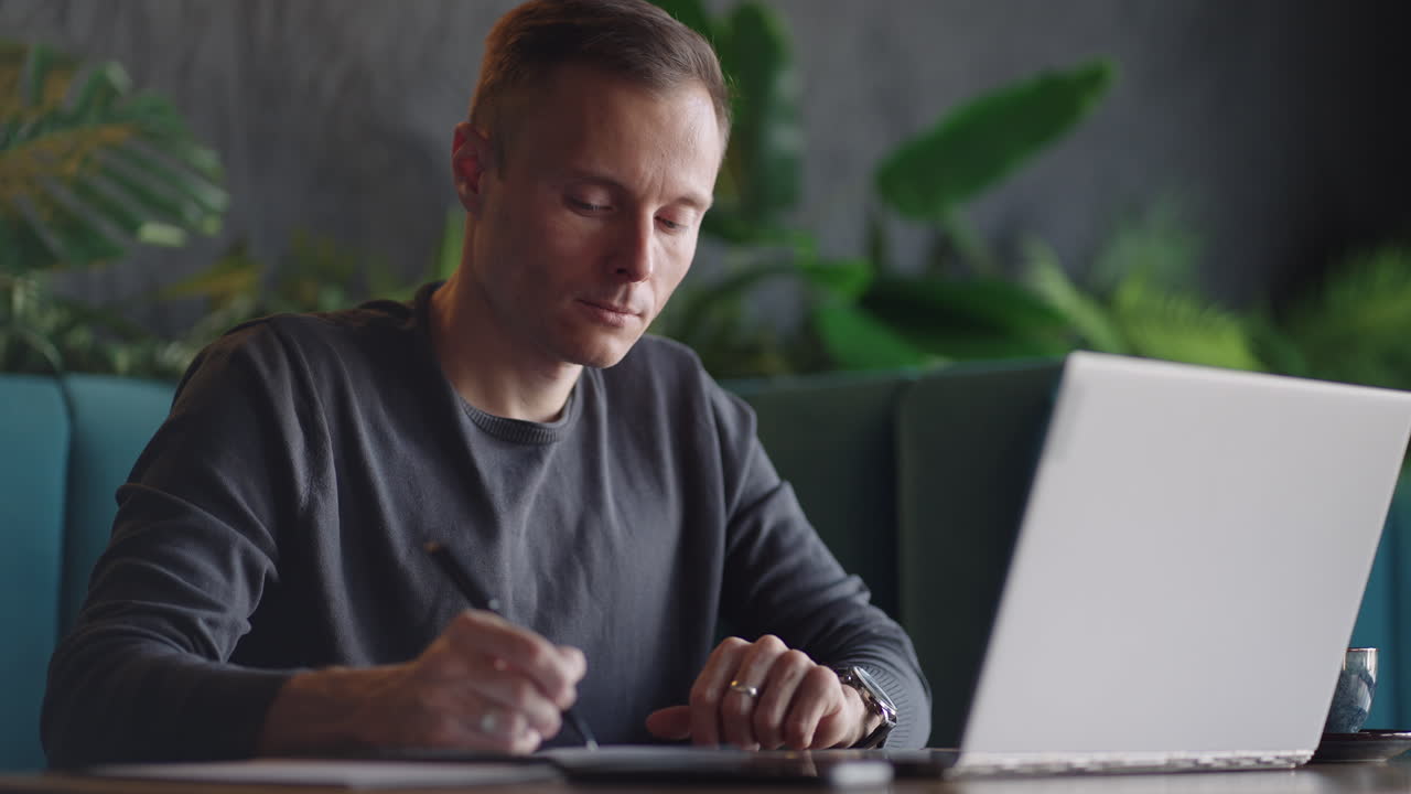 Hispanic latin man college student using laptop computer watching distance online learning seminar class remote university webinar or having virtual classroom meeting in university creative space.