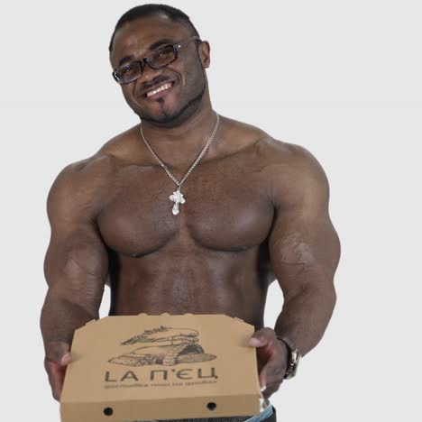 muscular man with pizza. african man holding pizza in his hands
