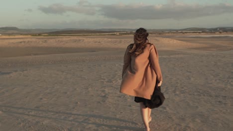 Tender-woman-on-seashore-on-windy-day