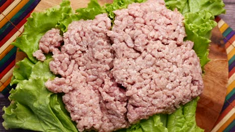 raw ground pork on lettuce